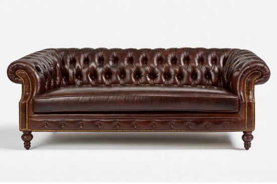 Lux & Borough Orleans style leather tuxedo sofa in warm brown leather featuring deep vertical channel tufting and a low profile base.
